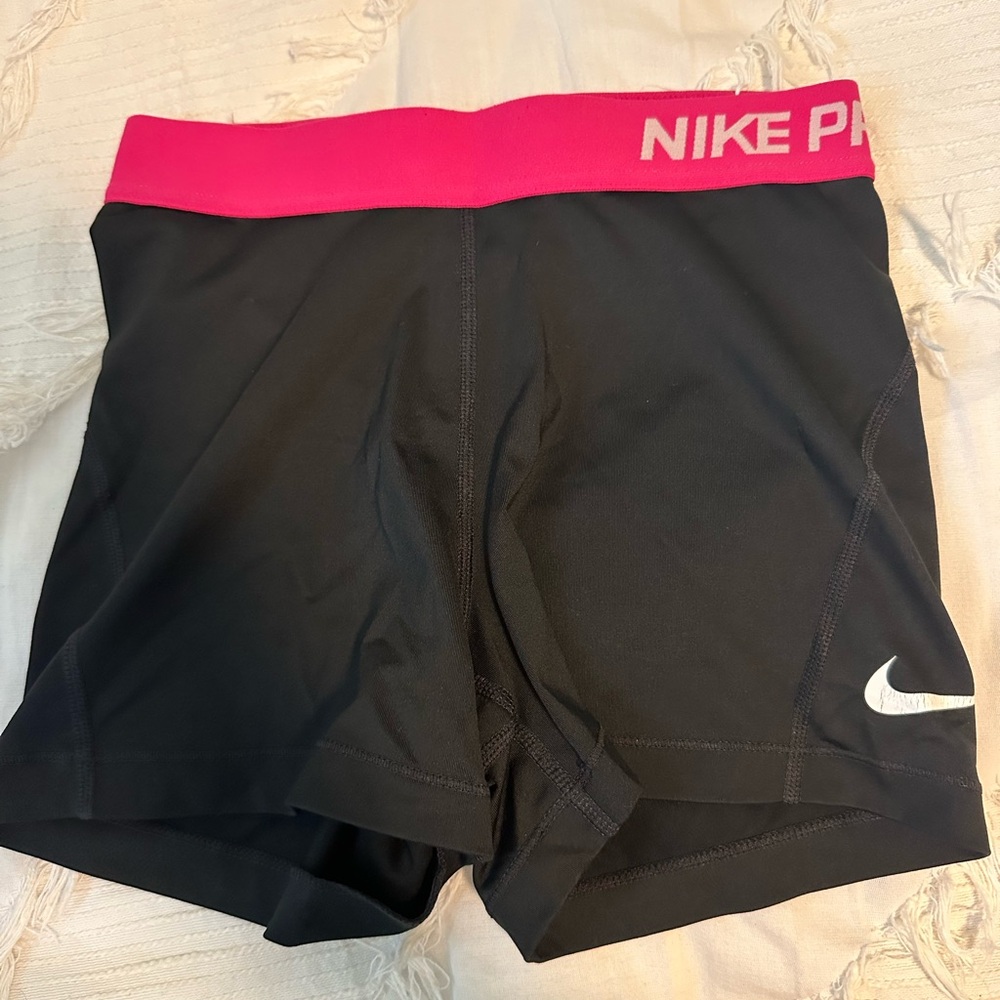 Nike pro compression shorts. Size small. Black with a pink stripe.